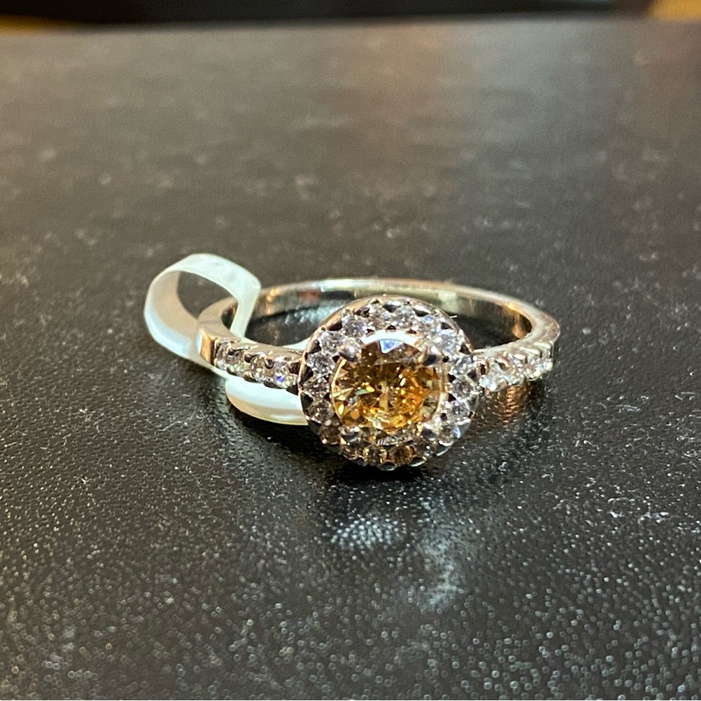 Topaz stone with small white stones on a sterling silver band size 9